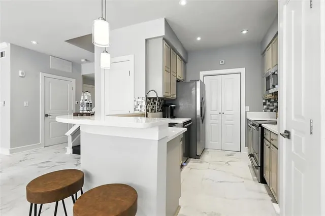 a kitchen with a refrigerator a sink and a stove