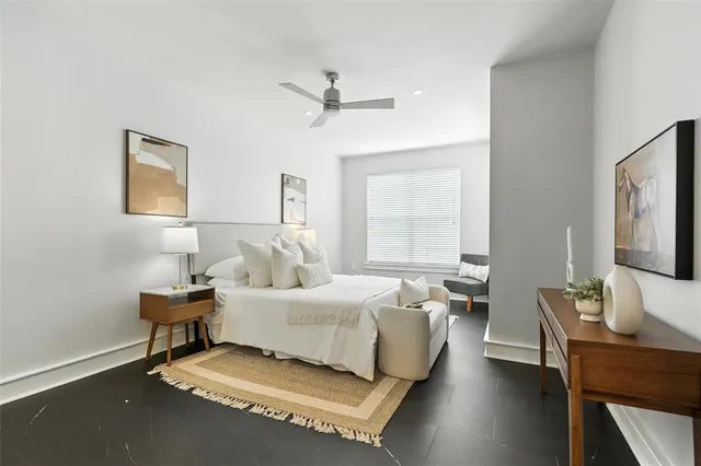 a bedroom with a bed and a desk