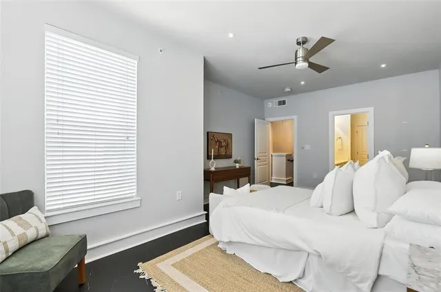 a bedroom with a bed wooden floor and window