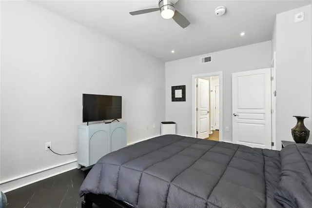 a bedroom with a bed and a flat screen tv