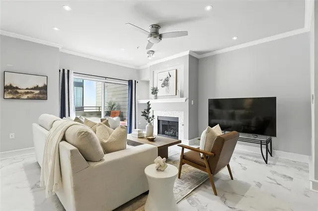 a living room with furniture a fireplace and a flat screen tv
