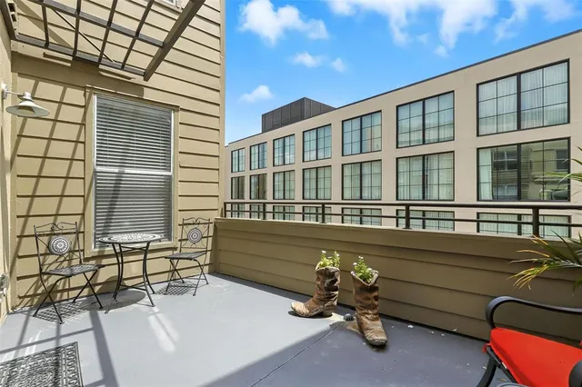 a roof deck with table and chairs