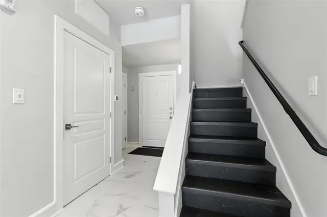 a view of entryway with wooden floor and stairs