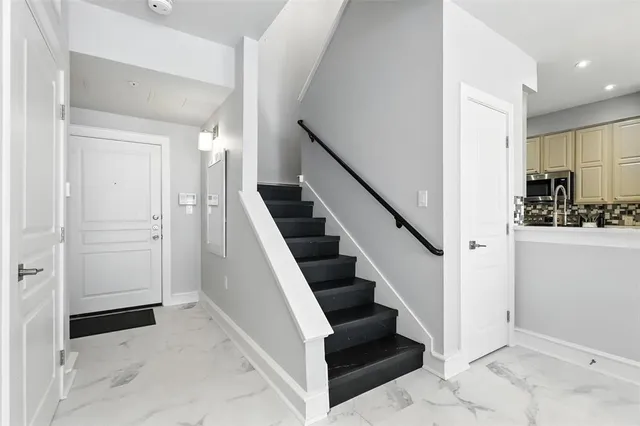 a view of entryway and hall with wooden floor
