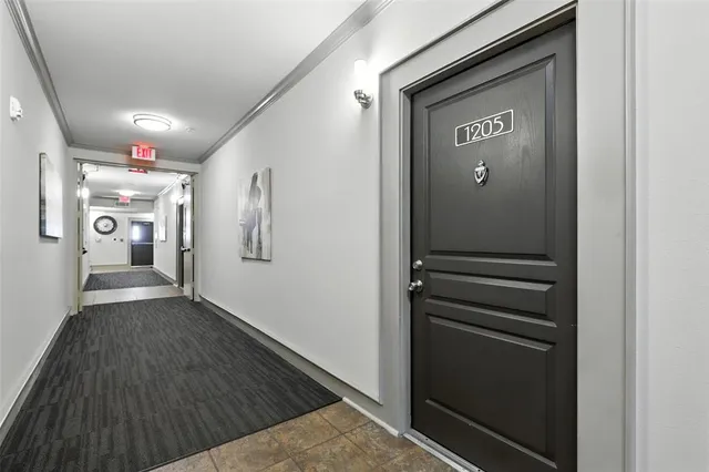 a view of hallway with stairs and wooden floor