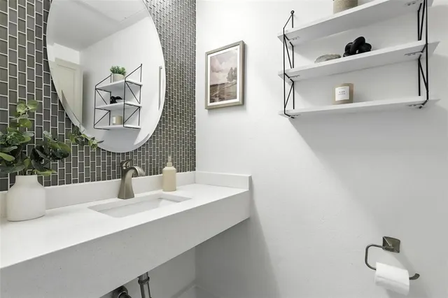 a bathroom with a sink mirror and vanity