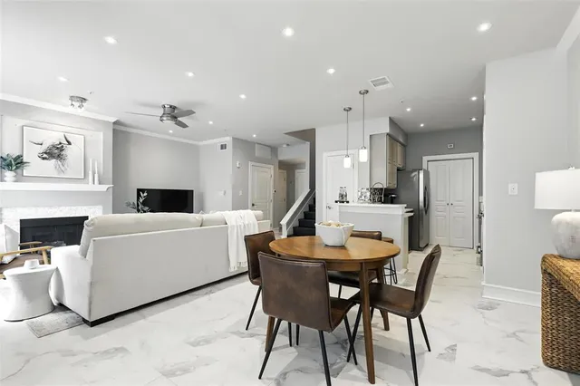 a view of a dining room with furniture and a chandelier