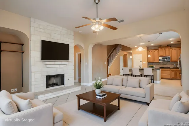 a view of empty room with fireplace and windows