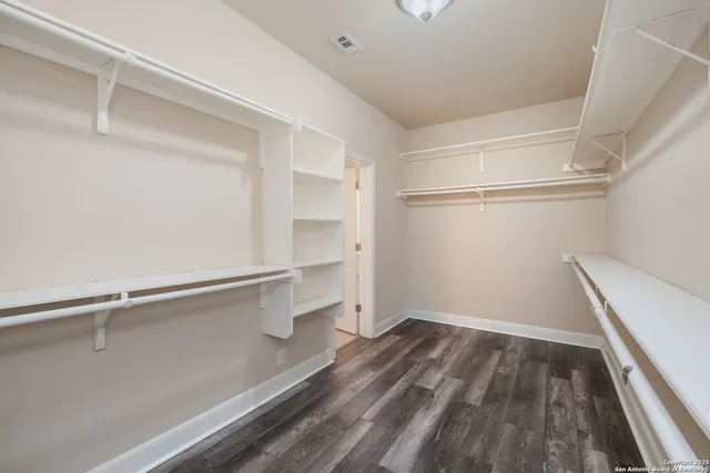 a view of staircase with wooden floor and a chandelier