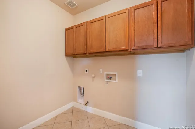 a room with wooden floor pool table and windows