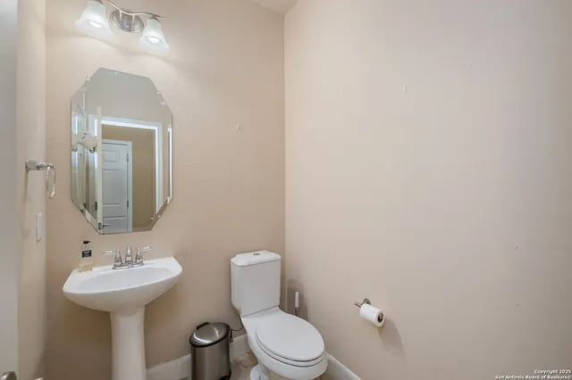 a bedroom with a bed table and a mirror