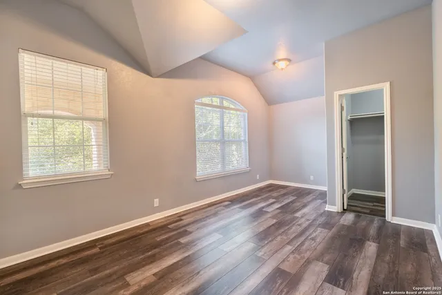 a view of a room with wooden floor and a bathroom