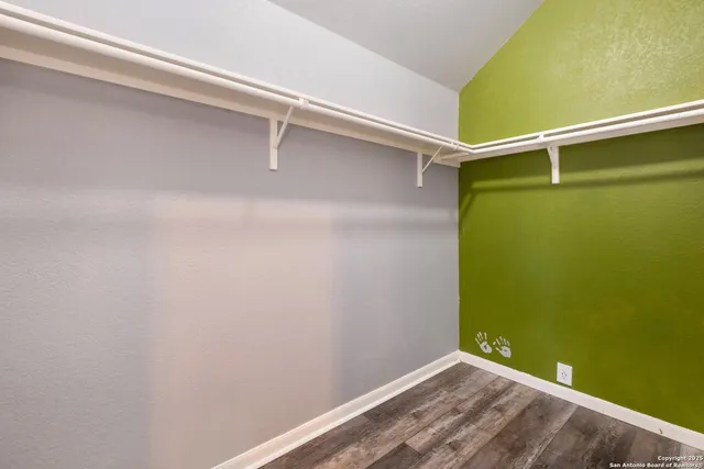 a view of a room with wooden floor and windows