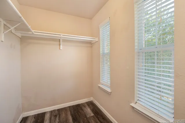 a backyard of a house with a garden and barbeque oven