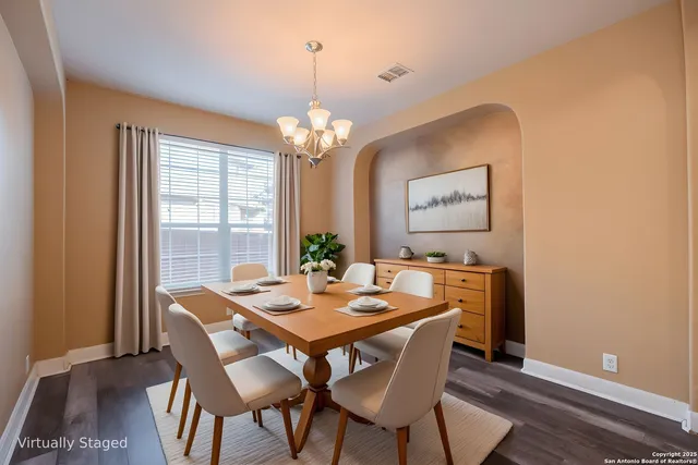 a kitchen with stainless steel appliances granite countertop a refrigerator a stove and a sink with wooden floor