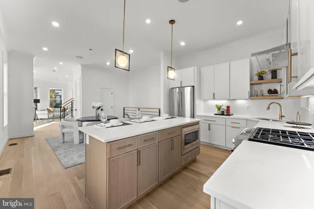 an open kitchen with a sink and breakfast area