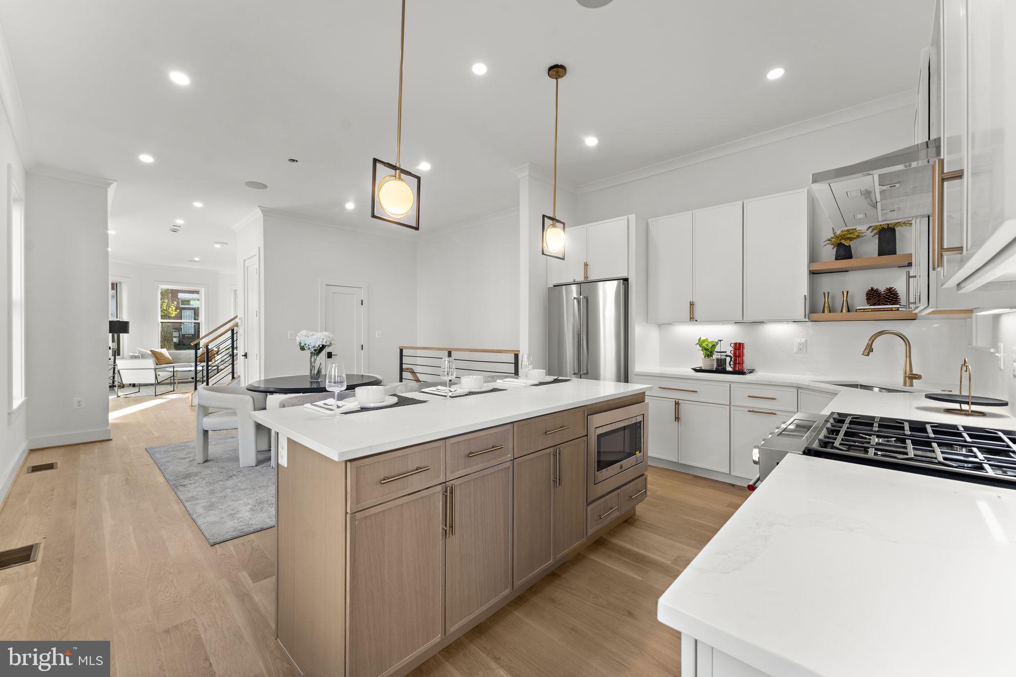 600 U Street Northwest Washington, DC 20001 - Photo 15 of 54 a kitchen with a sink a counter top space stainless steel appliances and cabinets