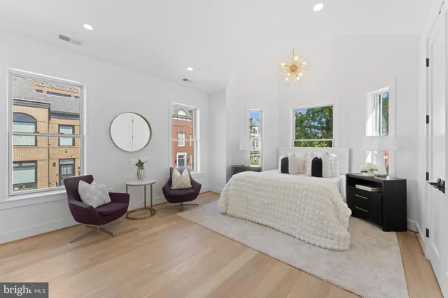 a spacious bedroom with a bed and a couch