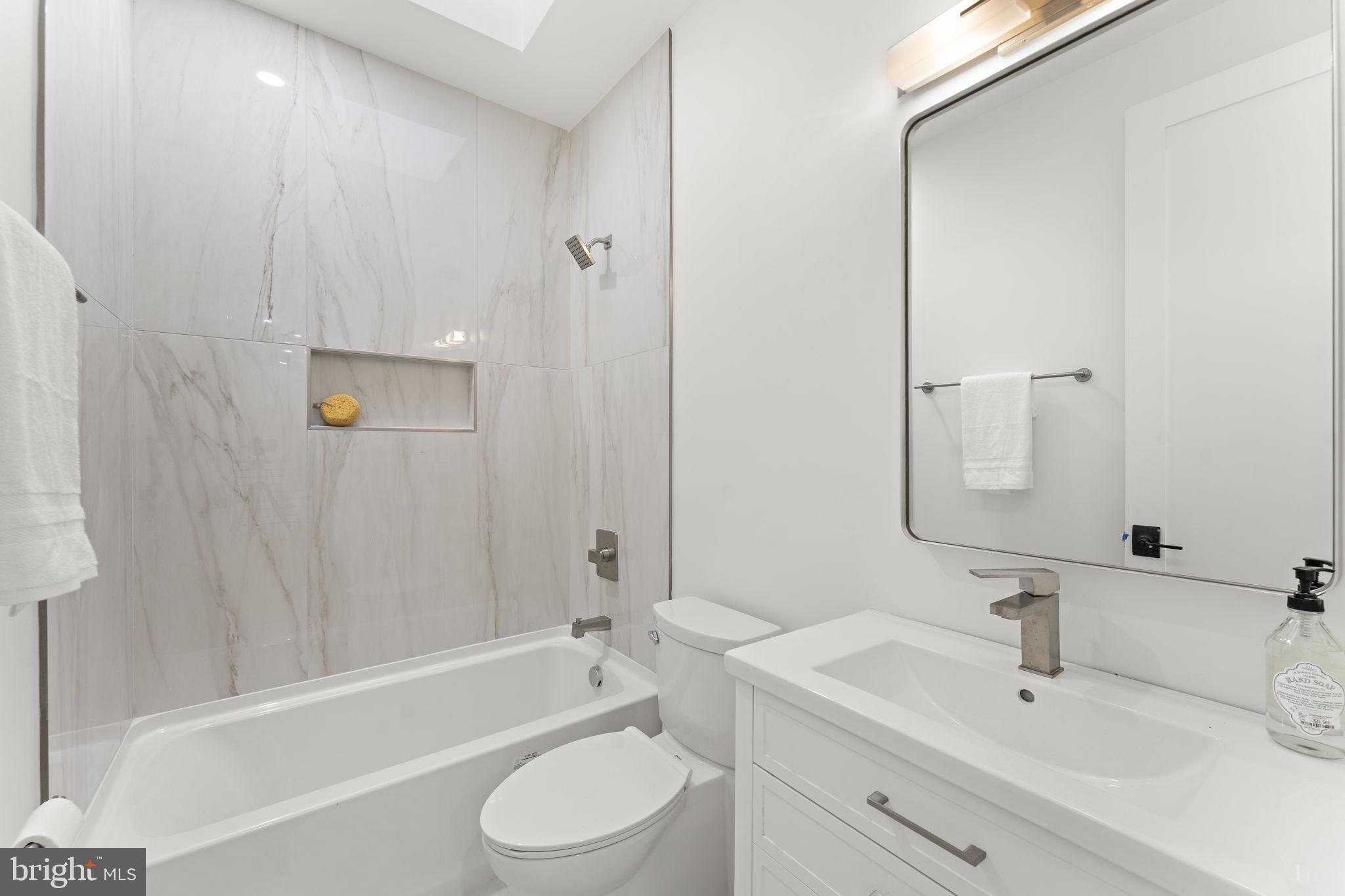 600 U Street Northwest Washington, DC 20001 - Photo 28 of 54 a bathroom with a toilet a sink a mirror a bathtub and shower