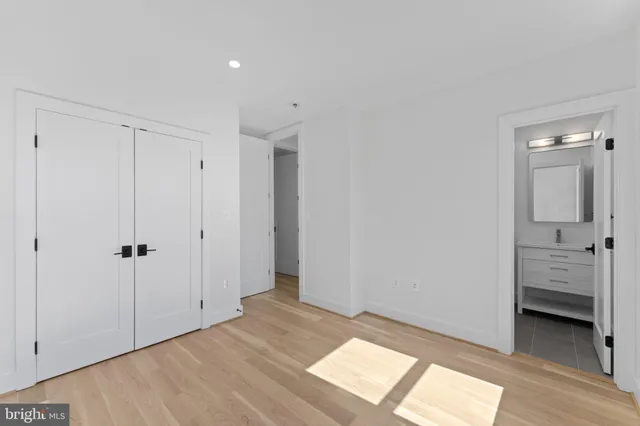 a view of a hallway with wooden floor and windows