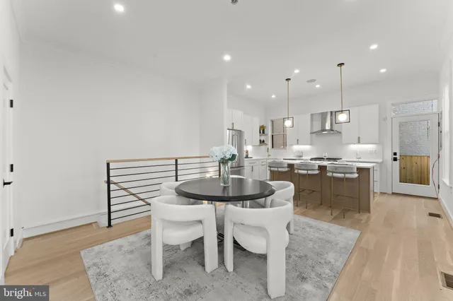a kitchen with a dining table chairs and microwave