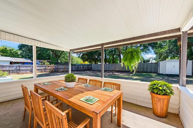 a view of a patio with a dining table and chairs