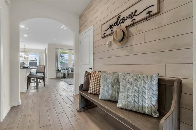 a living room with furniture potted plant and a large window