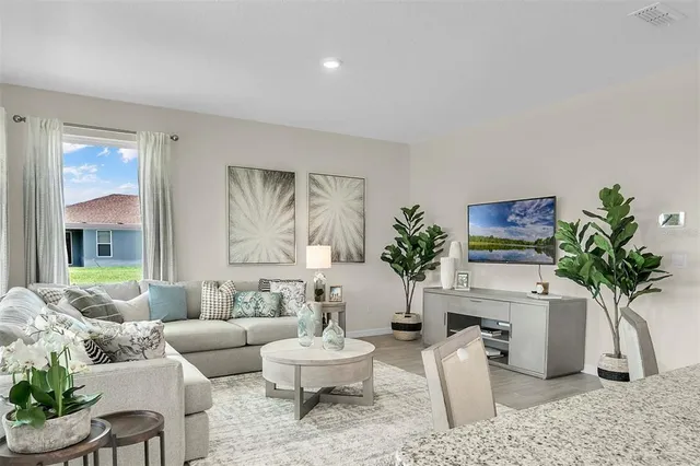 a dining room with furniture and garden view