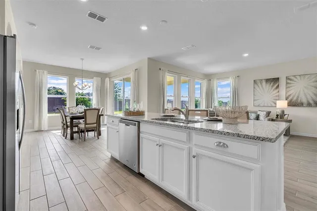 a view of a patio with a table chairs and a floor to ceiling window