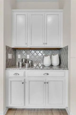 a living room with furniture and floor to ceiling windows