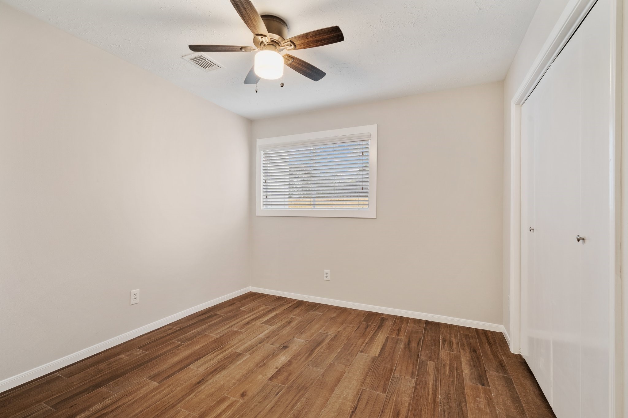 1931 Invermere Drive Spring, TX 77386 - Photo 17 of 24 wooden floor in an empty room with a window
