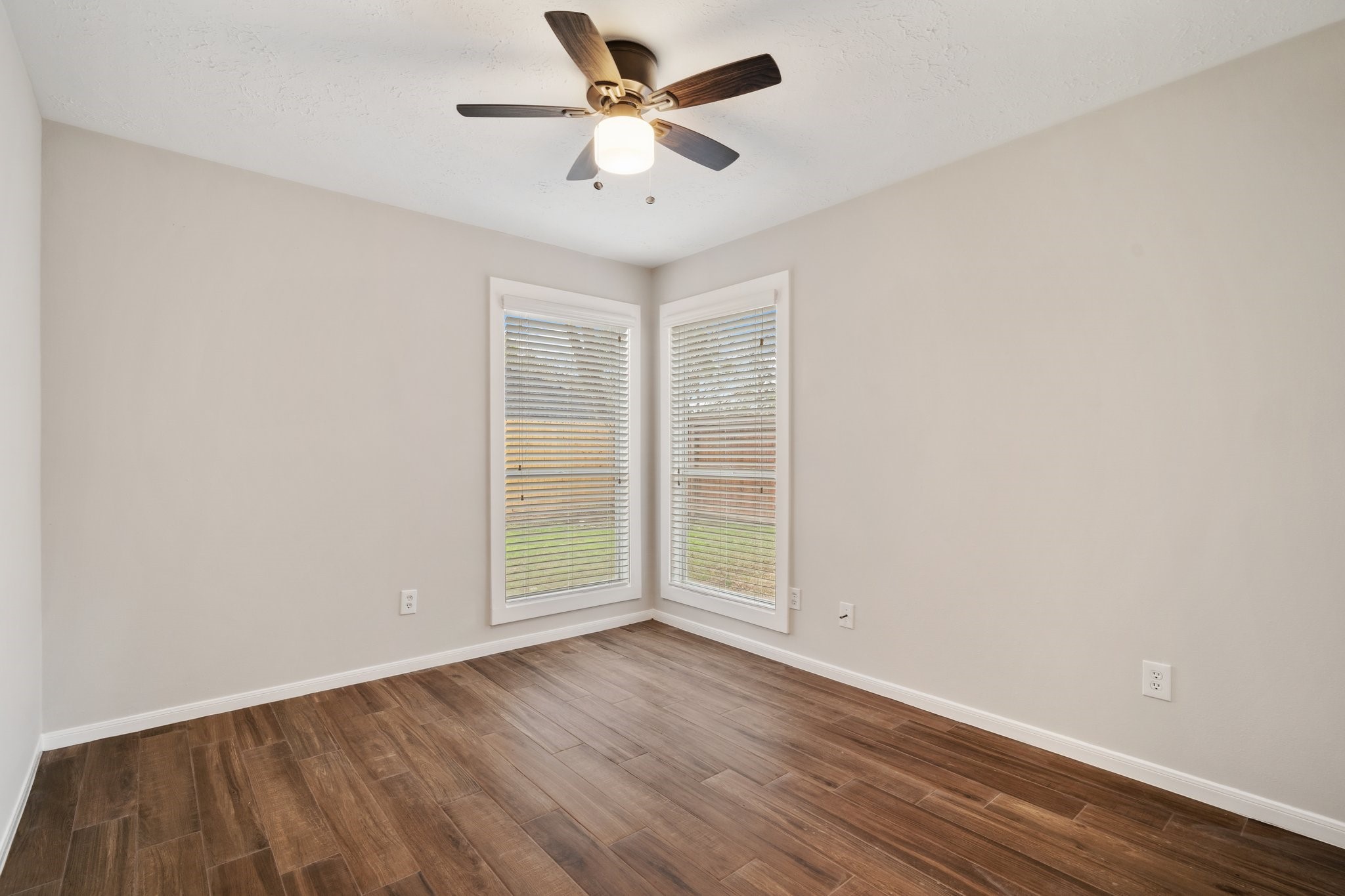 1931 Invermere Drive Spring, TX 77386 - Photo 18 of 24 an empty room with wooden floor and ceiling fan