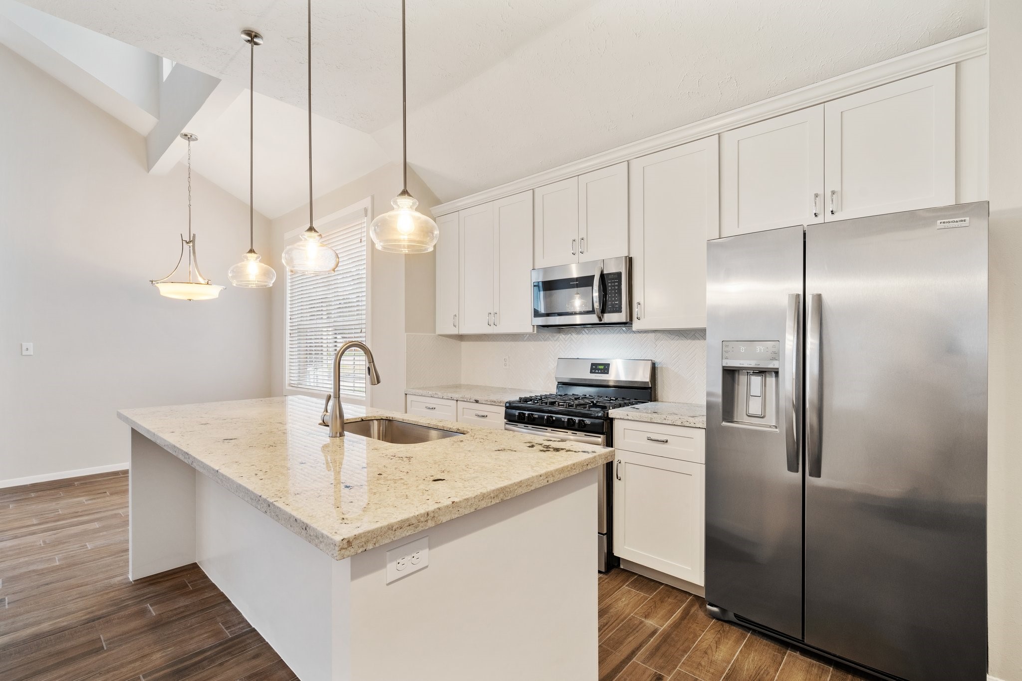 1931 Invermere Drive Spring, TX 77386 - Photo 2 of 24 a kitchen with a sink a counter space appliances and cabinets