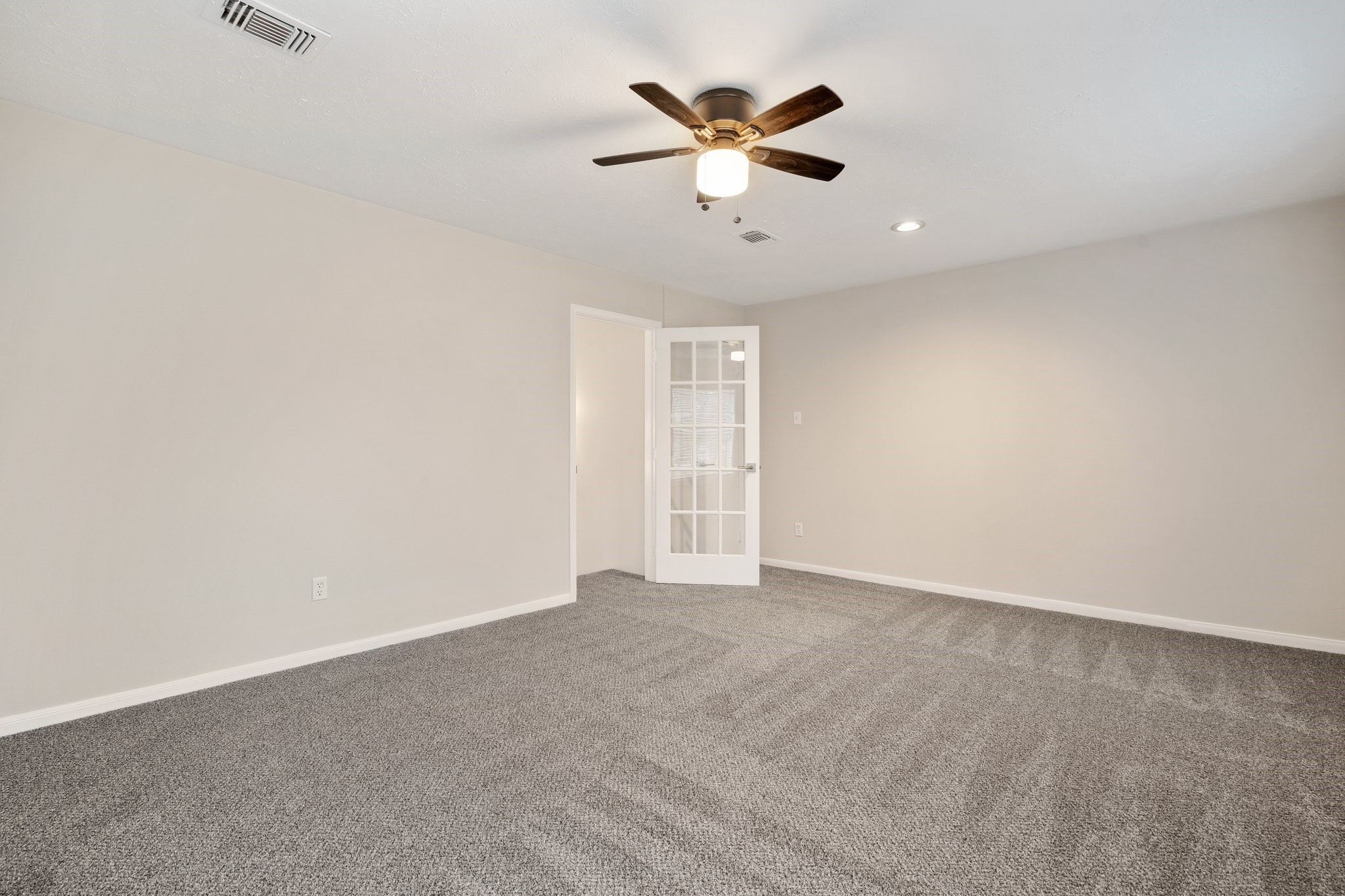 1931 Invermere Drive Spring, TX 77386 - Photo 21 of 24 an empty room with closet and a ceiling fan