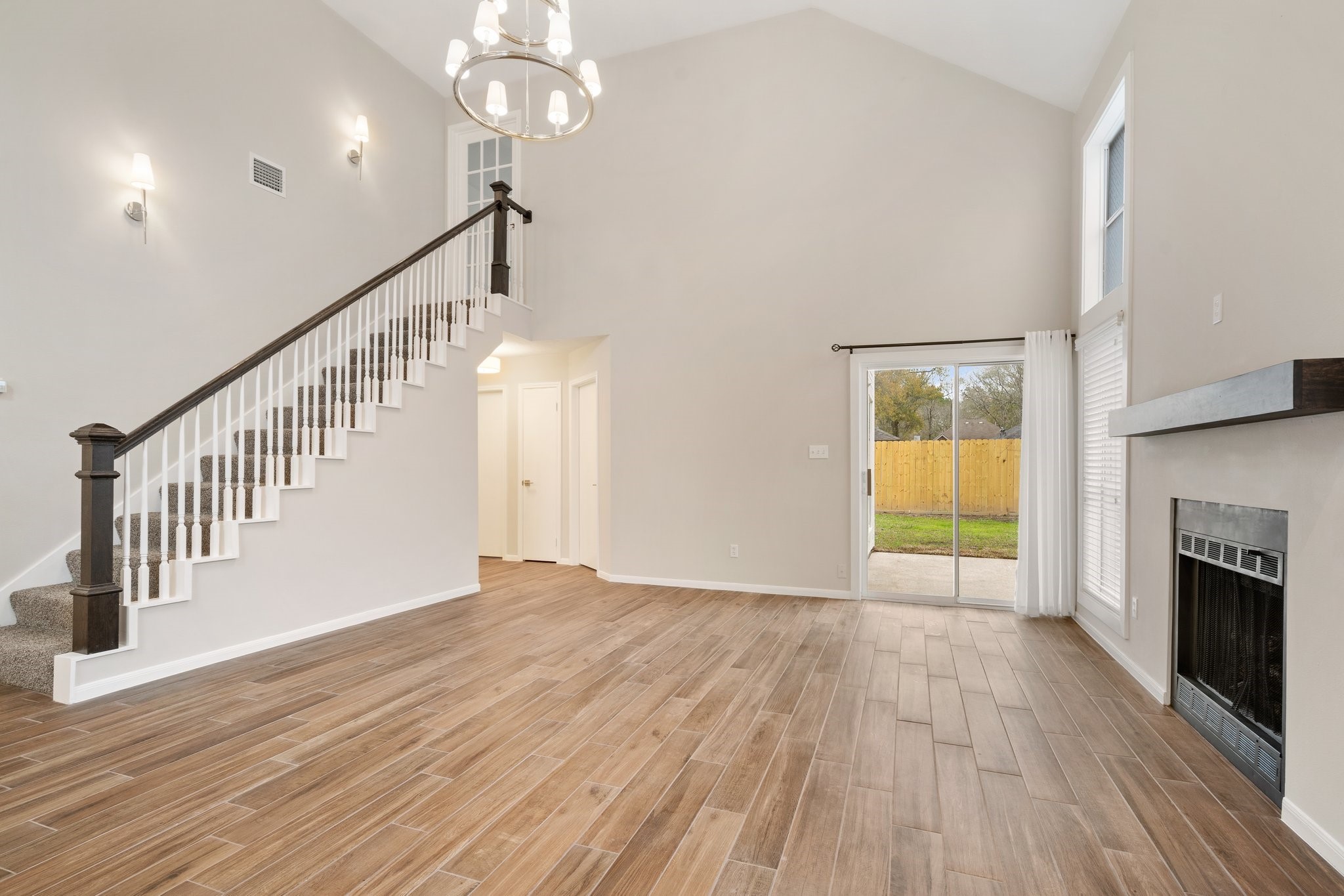 1931 Invermere Drive Spring, TX 77386 - Photo 5 of 24 a view of an empty room with wooden floor a fireplace and a window