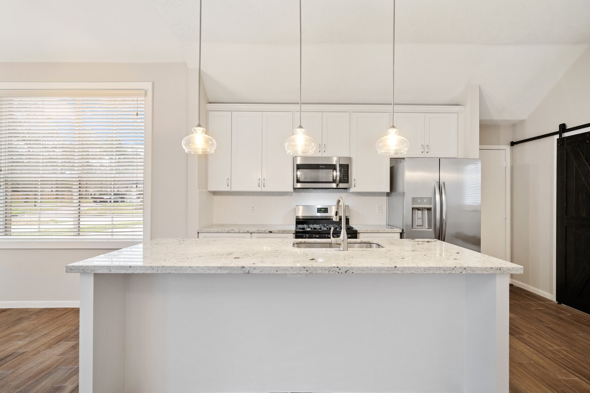 1931 Invermere Drive Spring, TX 77386 - Photo 8 of 24 a kitchen with kitchen island granite countertop a sink a counter space and stainless steel appliances