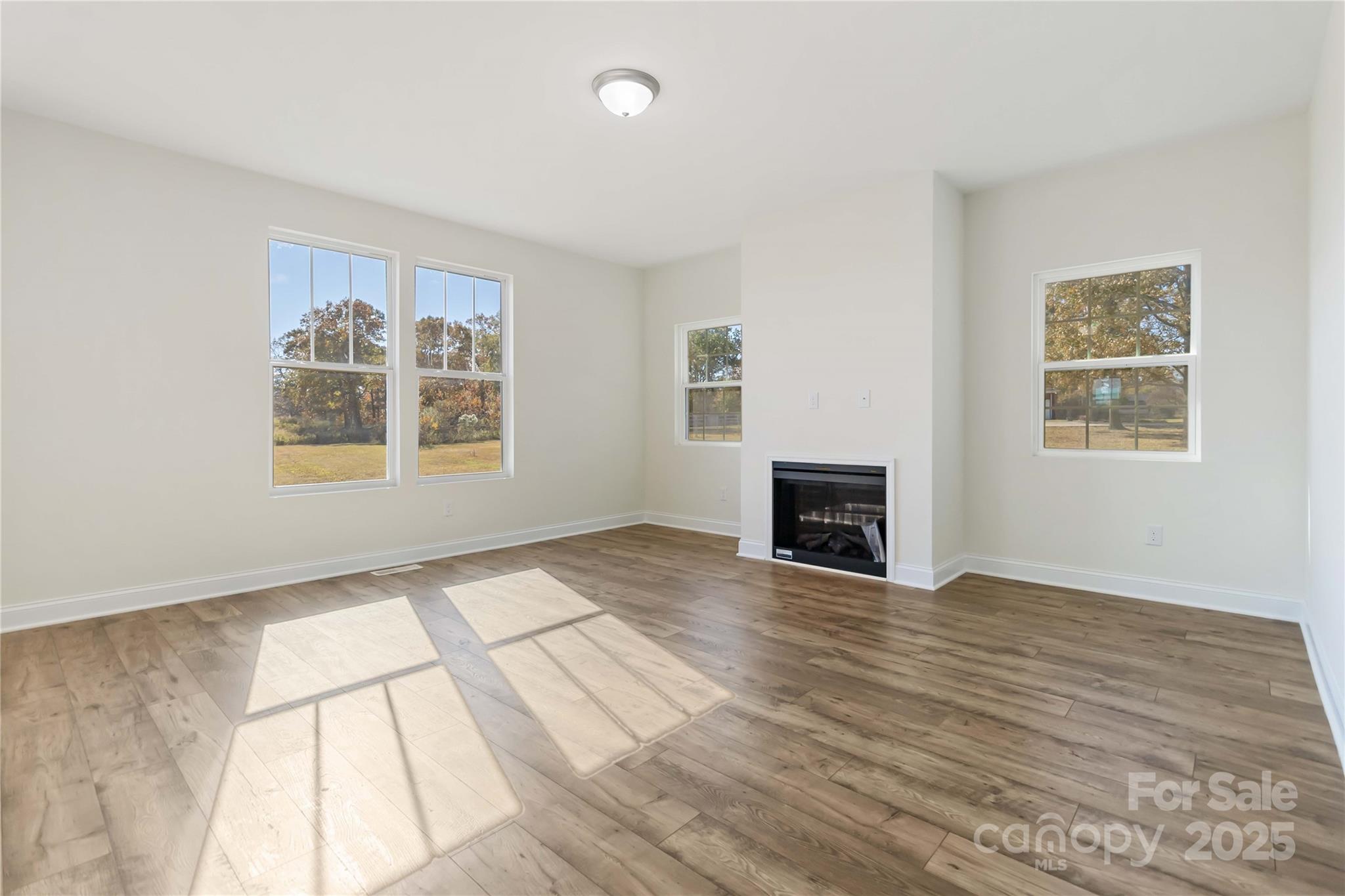 1006 Heath Helms Road Monroe, NC 28110 - Photo 11 of 48 a view of an empty room with wooden floor and a window