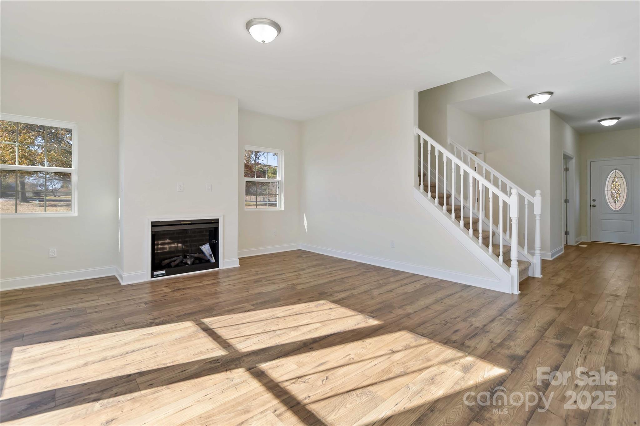 1006 Heath Helms Road Monroe, NC 28110 - Photo 12 of 48 a view of a livingroom with wooden floor and a fireplace