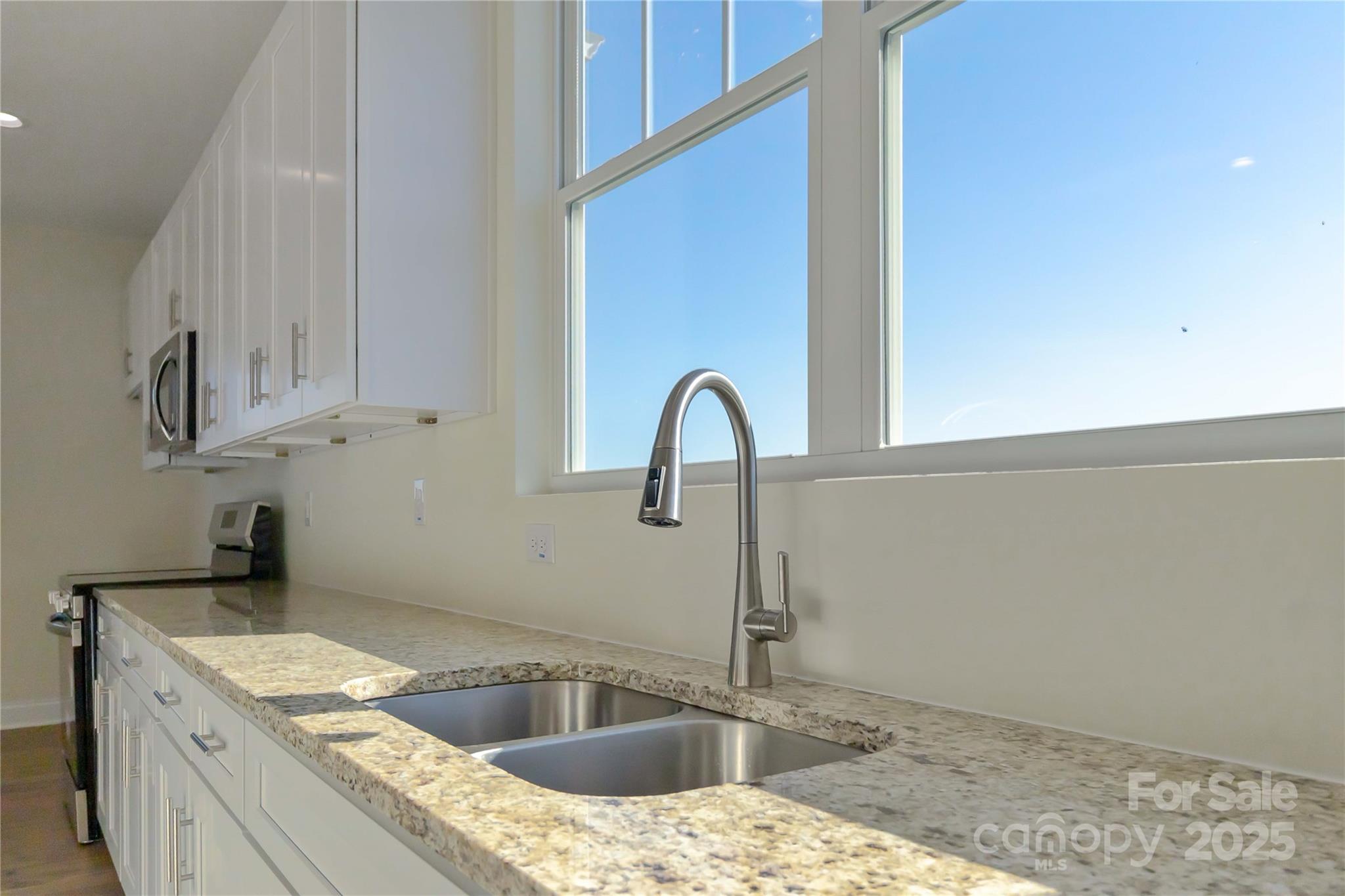 1006 Heath Helms Road Monroe, NC 28110 - Photo 17 of 48 a kitchen with granite countertop a sink and a stove