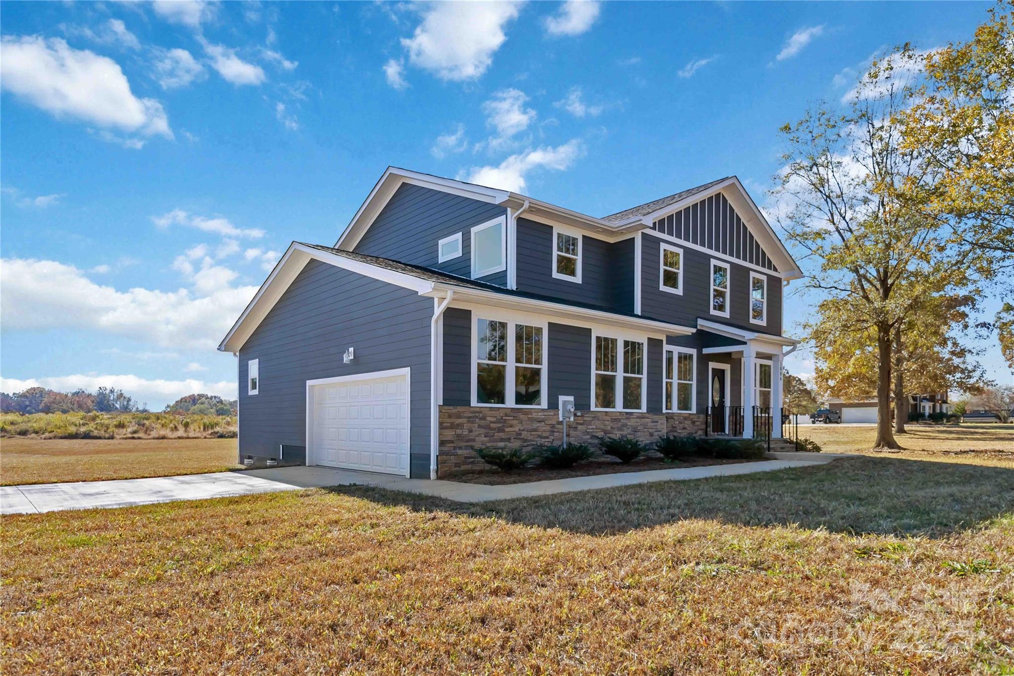 1006 Heath Helms Road Monroe, NC 28110 - Photo 3 of 48 a front view of a house with a yard