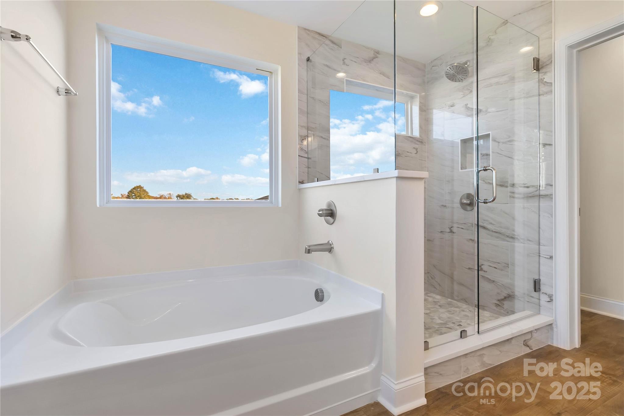 1006 Heath Helms Road Monroe, NC 28110 - Photo 34 of 48 a bathroom with a bathtub and a shower