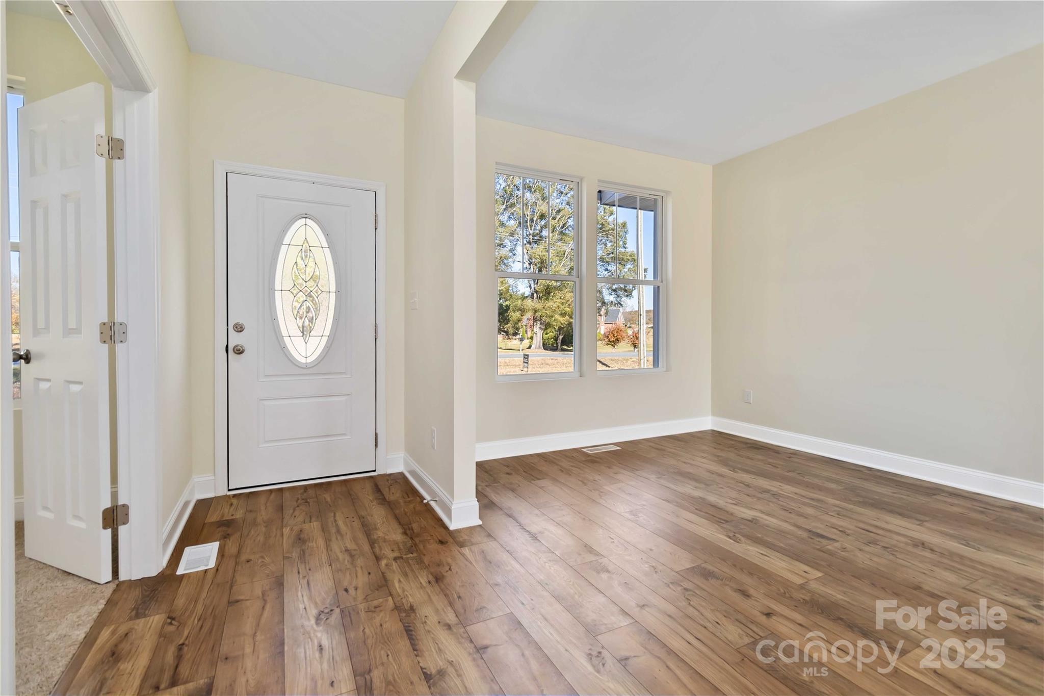 1006 Heath Helms Road Monroe, NC 28110 - Photo 5 of 48 an empty room with wooden floor and window