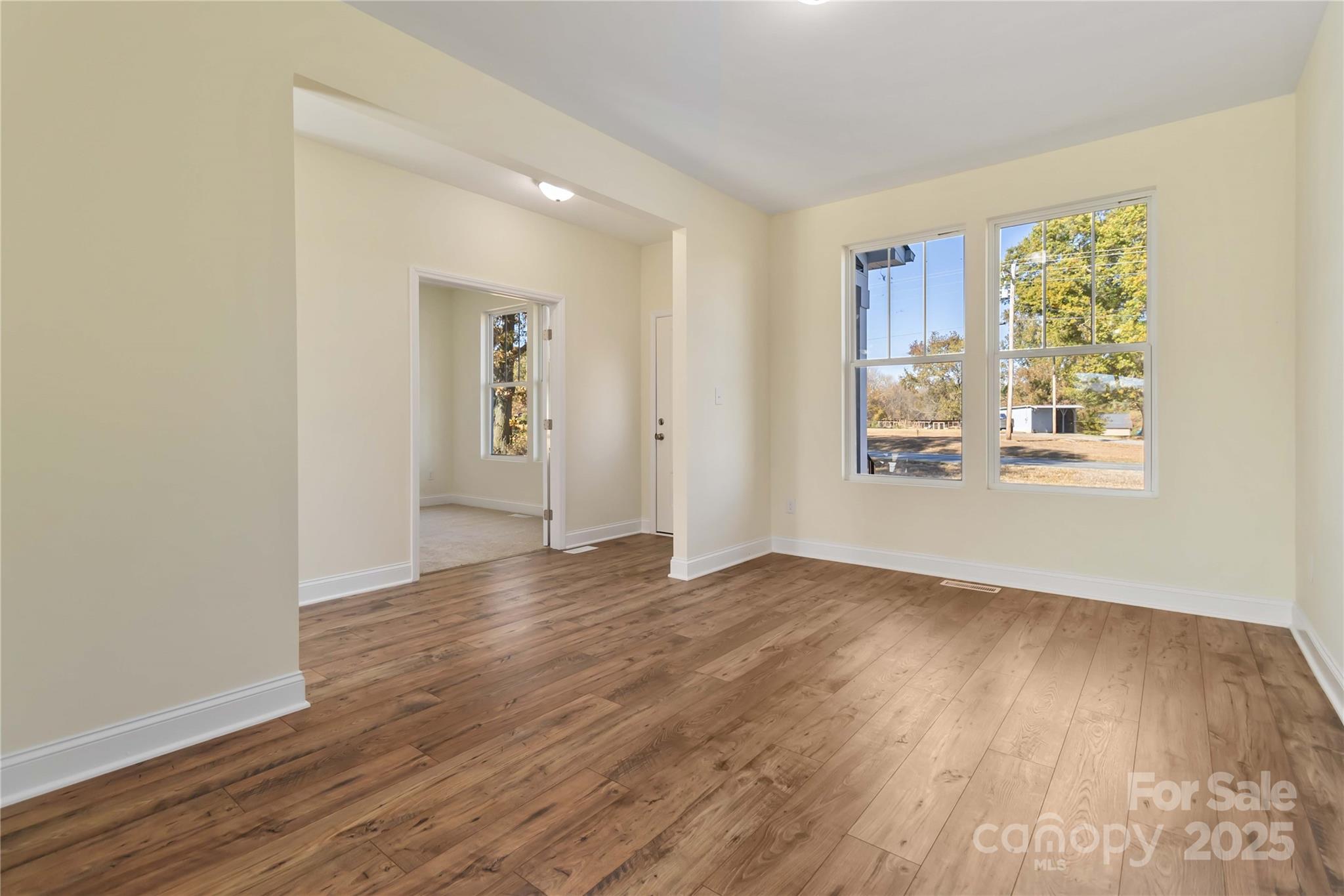 1006 Heath Helms Road Monroe, NC 28110 - Photo 8 of 48 an empty room with wooden floor and windows