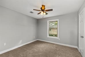 5210 Pickfair Street Houston, TX 77026 - Photo 13 of 18 an empty room with a window and a fan