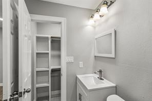 5210 Pickfair Street Houston, TX 77026 - Photo 15 of 18 a bathroom with a toilet sink and mirror