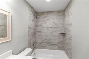 5210 Pickfair Street Houston, TX 77026 - Photo 18 of 18 a bathroom with a bathtub and a shower