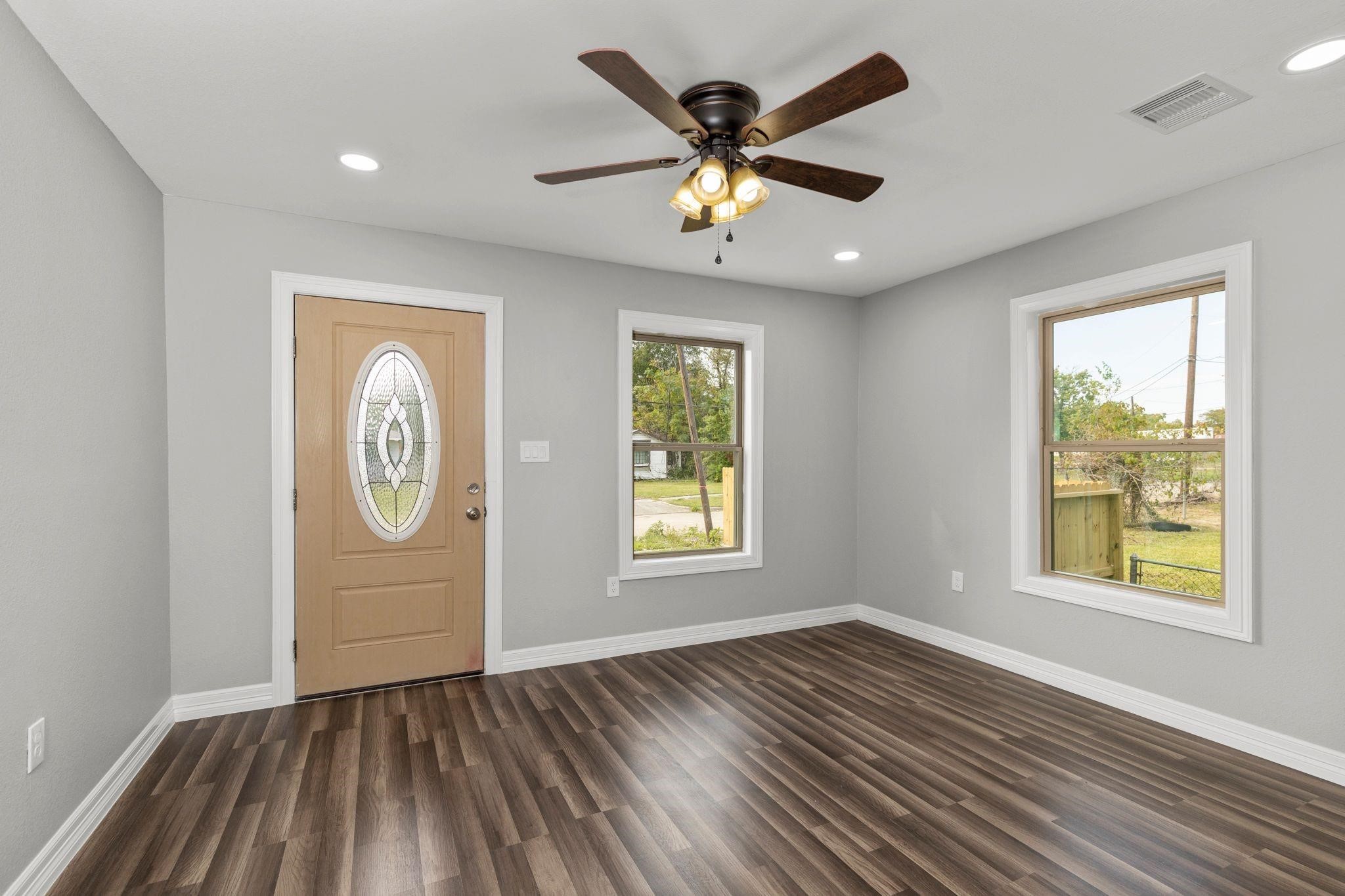5210 Pickfair Street Houston, TX 77026 - Photo 2 of 18 a view of an empty room with window and wooden floor