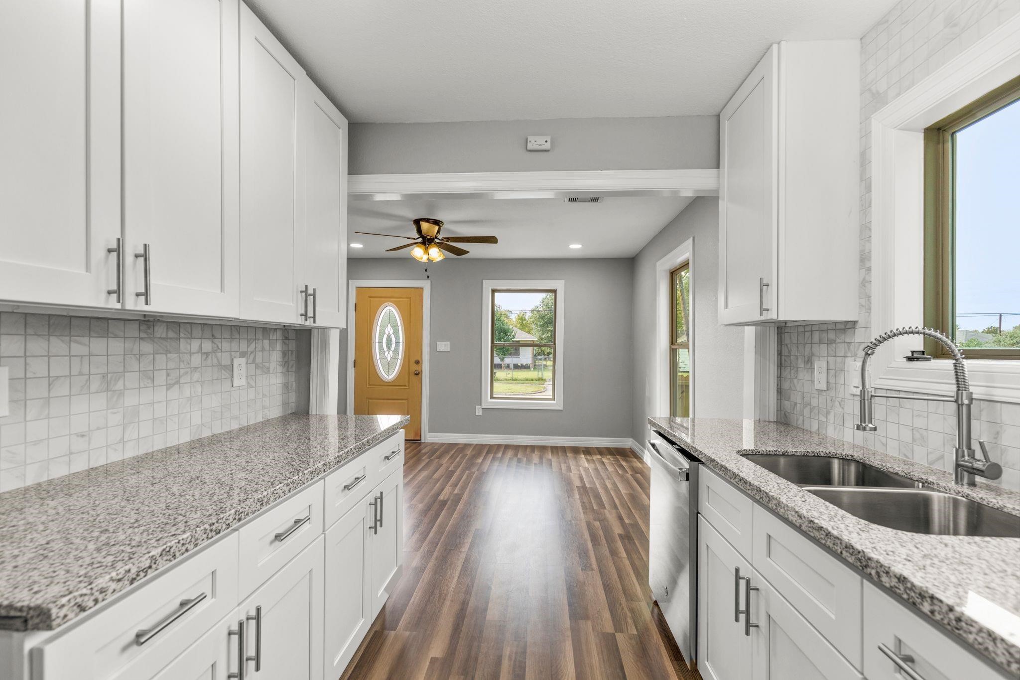 5210 Pickfair Street Houston, TX 77026 - Photo 3 of 18 a kitchen with granite countertop a sink a counter space cabinets and appliances