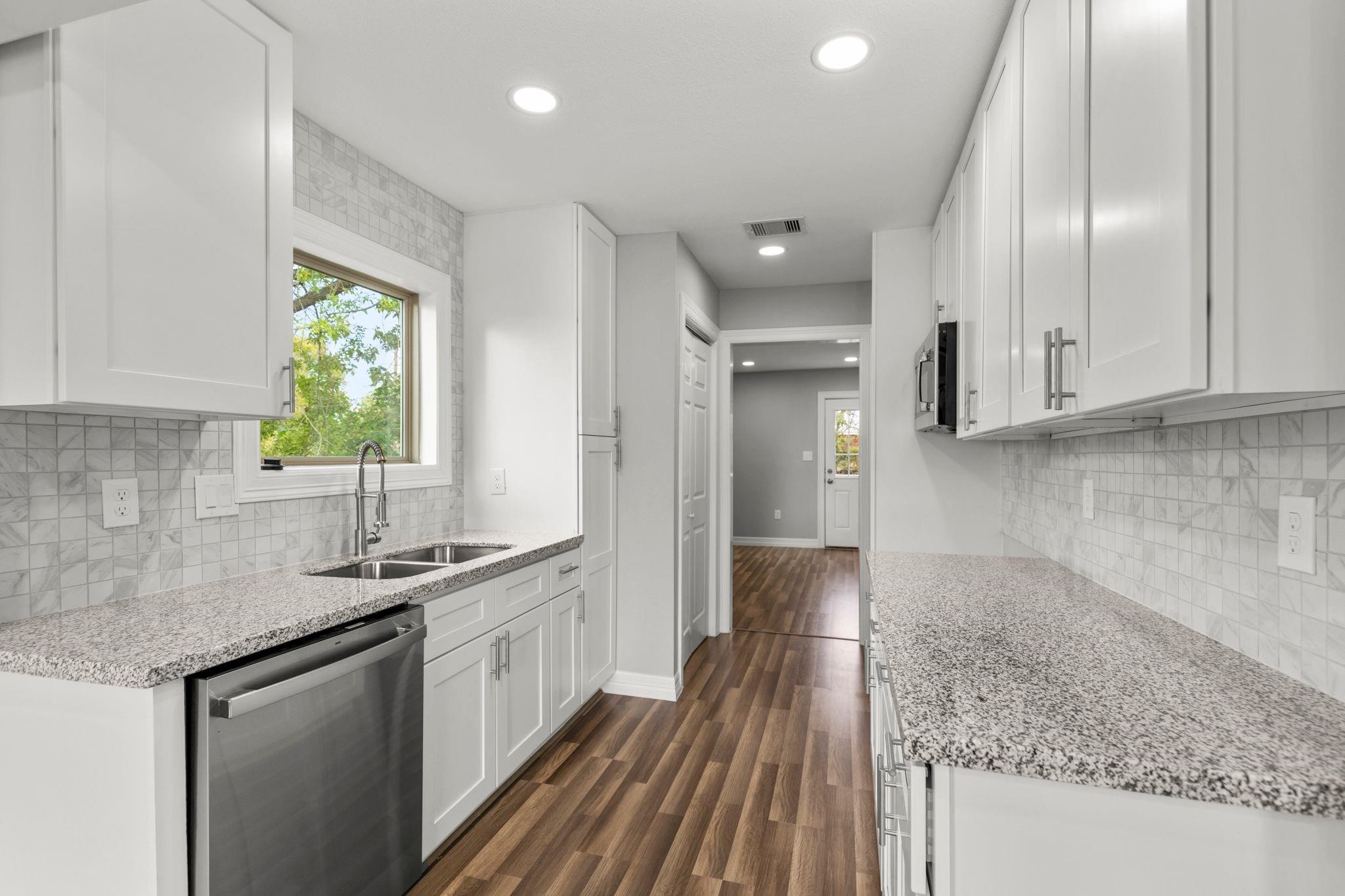 5210 Pickfair Street Houston, TX 77026 - Photo 4 of 18 a kitchen with granite countertop a sink stainless steel appliances and cabinets