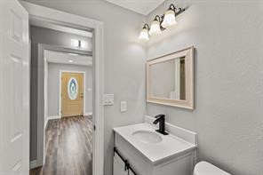 5210 Pickfair Street Houston, TX 77026 - Photo 5 of 18 a bathroom with a sink a mirror and a toilet